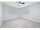 Inviting bedroom with natural light, neutral walls, and modern light wood-look flooring at 8375 Burgundy N Dr, Pinellas Park, FL 33781