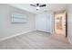 Bright bedroom featuring light wood-look floors, closet, and neutral paint at 8375 Burgundy N Dr, Pinellas Park, FL 33781