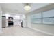 Bright kitchen featuring white cabinets, stainless steel appliances, and light wood-look floors at 8375 Burgundy N Dr, Pinellas Park, FL 33781