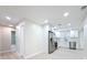 Modern kitchen seamlessly connected to the adjacent rooms, boasting stainless steel appliances and white cabinetry at 8375 Burgundy N Dr, Pinellas Park, FL 33781
