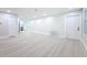 Spacious living room with light wood floors and a modern, minimalist design, offering a versatile living space at 8375 Burgundy N Dr, Pinellas Park, FL 33781