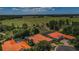Overhead shot of the neighborhood highlighting multiple residences with clay tile roofs and green landscape at 1012 Tuscany Dr, Trinity, FL 34655