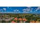 Expansive aerial view showcases the community, surrounding greenery, and blue skies at 1012 Tuscany Dr, Trinity, FL 34655