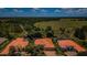 Expansive aerial view of a community showcasing well-maintained homes with clay tile roofs at 1012 Tuscany Dr, Trinity, FL 34655