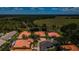 High-angle view showcasing neighborhood homes featuring beautiful landscaping, clay tile roofs, and cul-de-sac at 1012 Tuscany Dr, Trinity, FL 34655