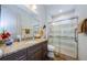 Bathroom with granite countertop, glass shower and tile floors at 1012 Tuscany Dr, Trinity, FL 34655