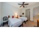 Bright bedroom with two beds, ceiling fan, and comfortable furnishings for a relaxing stay at 1012 Tuscany Dr, Trinity, FL 34655