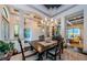 Formal dining room with a coffered ceiling, chandelier lighting, and an open view of the living area at 1012 Tuscany Dr, Trinity, FL 34655