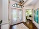 Grand foyer featuring elegant double doors, hardwood floors, and views into the study at 1012 Tuscany Dr, Trinity, FL 34655