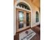 Elegant front door with decorative glass, sidelights, and a custom welcome mat at 1012 Tuscany Dr, Trinity, FL 34655