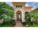 Beautiful front entrance with double doors, manicured landscaping, and a brick-paved walkway at 1012 Tuscany Dr, Trinity, FL 34655