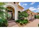 Welcoming front entrance with lush landscaping, arched accents, and a brick-paved walkway at 1012 Tuscany Dr, Trinity, FL 34655
