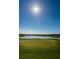 Scenic golf course view features a lush green with a water hazard and sunny skies at 1012 Tuscany Dr, Trinity, FL 34655