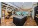 Open-concept kitchen and living room with island and coffered ceiling at 1012 Tuscany Dr, Trinity, FL 34655