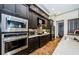 Modern kitchen featuring stainless steel appliances and dark wood cabinetry at 1012 Tuscany Dr, Trinity, FL 34655