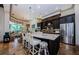 Gourmet kitchen with dark wood cabinets, granite countertops, stainless steel appliances, and breakfast bar seating at 1012 Tuscany Dr, Trinity, FL 34655