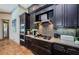 Gourmet kitchen with gas range, mosaic backsplash, and stainless steel hood at 1012 Tuscany Dr, Trinity, FL 34655