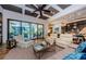 Spacious living room featuring comfortable seating, coffered ceiling, and sliding glass doors to the pool area at 1012 Tuscany Dr, Trinity, FL 34655