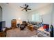 Comfortable living room featuring carpeted floors, ceiling fan, and comfortable seating at 1012 Tuscany Dr, Trinity, FL 34655