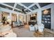 Open-concept living room boasts a coffered ceiling, built-in shelving, and neutral decor at 1012 Tuscany Dr, Trinity, FL 34655
