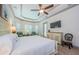Bright main bedroom featuring tray ceiling, sitting area, and access to lanai and pool at 1012 Tuscany Dr, Trinity, FL 34655