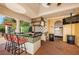 Well-equipped outdoor kitchen with granite counters, tile accents, and bar seating at 1012 Tuscany Dr, Trinity, FL 34655