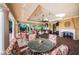 Elegant outdoor living area with seating, a fireplace, and a built-in kitchen at 1012 Tuscany Dr, Trinity, FL 34655