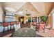 Sophisticated outdoor living space with a kitchen, fireplace, and comfortable seating at 1012 Tuscany Dr, Trinity, FL 34655