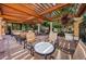 Charming patio area with a pergola, comfortable seating, and lush greenery, perfect for outdoor relaxation and gatherings at 1012 Tuscany Dr, Trinity, FL 34655