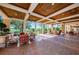 Large covered patio featuring brick flooring, a wood ceiling, and outdoor seating at 1012 Tuscany Dr, Trinity, FL 34655
