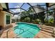 Enjoy this beautiful pool and jacuzzi under a screened enclosure surrounded by lush landscaping at 1012 Tuscany Dr, Trinity, FL 34655