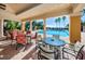 Inviting pool patio with brick pavers, elegant tables, chairs, and serene views of the sparkling pool and palm trees at 1012 Tuscany Dr, Trinity, FL 34655