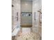 Walk-in shower featuring tiled walls, built-in seating, and toiletry niche at 1012 Tuscany Dr, Trinity, FL 34655