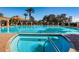 Inviting swimming pool and spa with palm trees, lush landscaping, and elegant architecture, creating a luxurious retreat at 1012 Tuscany Dr, Trinity, FL 34655