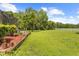 Expansive backyard featuring lush lawn, mature trees, and a white fence enclosing the property's perimeter at 10193 Wallien Dr, Brooksville, FL 34601