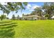 Large lawn with house, pool, and covered lanai at 10193 Wallien Dr, Brooksville, FL 34601