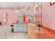 Bright bathroom with tiled floor, double vanity, and a soaking tub beneath decorative floral wallpaper at 10193 Wallien Dr, Brooksville, FL 34601