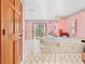 This bathroom features a large soaking tub, unique tile flooring, and access to the outdoor space at 10193 Wallien Dr, Brooksville, FL 34601