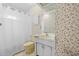Small bathroom with vintage yellow fixtures, floral wallpaper, and a shower with a curtain at 10193 Wallien Dr, Brooksville, FL 34601