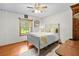 Charming bedroom with white walls, hardwood floors, and natural light from the window at 10193 Wallien Dr, Brooksville, FL 34601