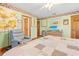 Cozy bedroom with light green walls, floral accents, hardwood floors, and comfortable armchair at 10193 Wallien Dr, Brooksville, FL 34601