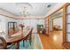 Traditional dining room featuring a chandelier, floral arrangements, and doorway to the living room at 10193 Wallien Dr, Brooksville, FL 34601