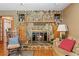 Living room stone fireplace with a wooden mantle and decorative items at 10193 Wallien Dr, Brooksville, FL 34601