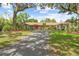 Spacious home with mature trees, charming front entrance, and long driveway leading to the home at 10193 Wallien Dr, Brooksville, FL 34601
