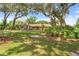 Front yard of the home, showcasing the curb appeal with mature trees and lush landscaping at 10193 Wallien Dr, Brooksville, FL 34601