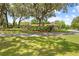 Charming home with a circular driveway, lush lawn, and mature landscaping, showcasing curb appeal at 10193 Wallien Dr, Brooksville, FL 34601