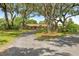 A wide view of a beautiful home with mature trees and a long driveway in a lush, green setting at 10193 Wallien Dr, Brooksville, FL 34601