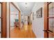 Hallway view featuring hardwood floors, decorative walls, and access to multiple rooms at 10193 Wallien Dr, Brooksville, FL 34601