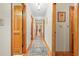 Long hallway with wood floors and doors leading to other rooms, with area rug at 10193 Wallien Dr, Brooksville, FL 34601