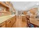 Spacious kitchen with wooden cabinets, an island, and hardwood flooring, perfect for Gathering gatherings at 10193 Wallien Dr, Brooksville, FL 34601